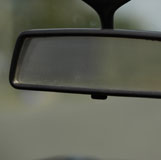 Looking into a automobile's rearview mirror