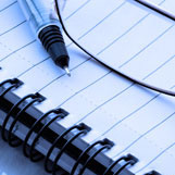 Pen and eyeglasses on a notebook